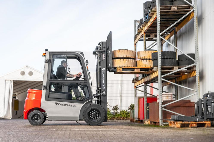 A Compartec forklift loading tyres in a warehouse